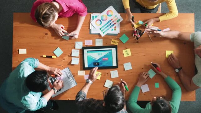 Time lapse of smart business people working together to design web design. Aerial view of designer brainstorming and discussing about website interface for computer or digital application. Symposium.
