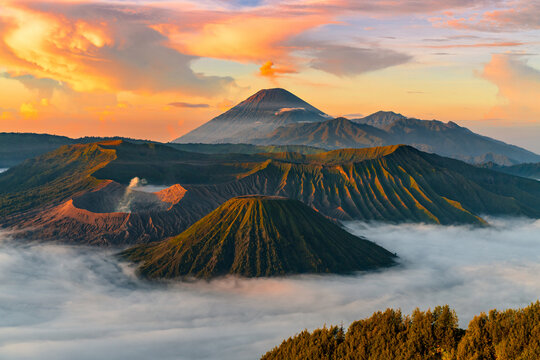 landscape Mountain Bromo volcano at sunrise and the mist Foreground Tengger Semeru National Park,Indonesia - Powered by Adobe