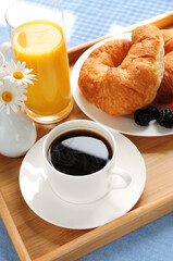 Breakfast served on a tray on a sunny morning