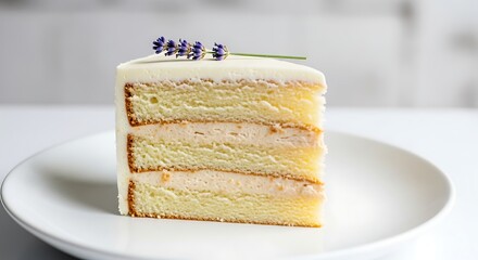 A delicious slice of layered vanilla cake with white frosting, creamy filling, and a delicate lavender sprig on a white plate.