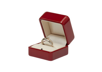 A silver engagement ring with a small diamond presented in an open, glossy red jewelry box on a white background.