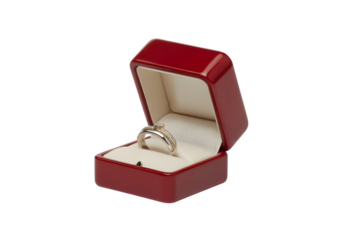 A silver engagement ring with a small diamond presented in an open, glossy red jewelry box on a white background.