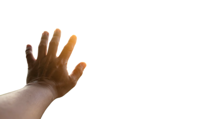 A human hand outstretched against a black backdrop, with bright light outlining fingers