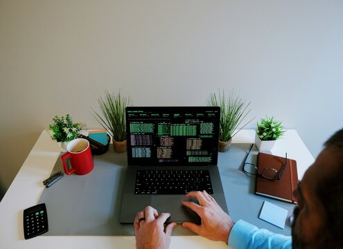 Middle Aged Male Red Team Cybersecurity Researcher Conducting Offsite Remote Corporate Penetration Test of Network Security - White Hat Hacker Concept