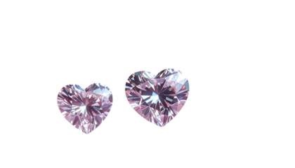 Two heart-shaped, shimmering, light-pink gems against a stark, black background