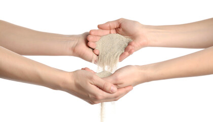Two sets of hands, one pouring sand into the other. Symbol of time