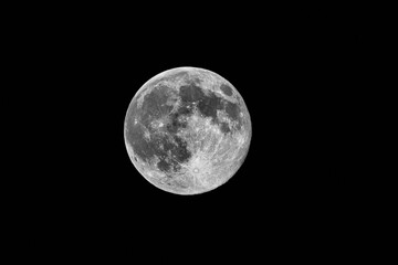 Bright moon surface high contrast, Sharp black and white moon highlighting textured crater features, Highcontrast monochrome depiction of lunar surface with deep shadows and detailed craters