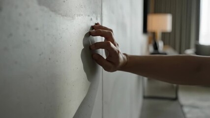 Hand Touching Concrete Wall: Texture, Light, and Shadow