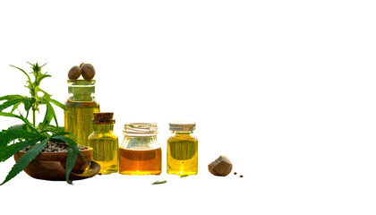 A close-up showcases small glass jars filled with golden oils, cannabis plant