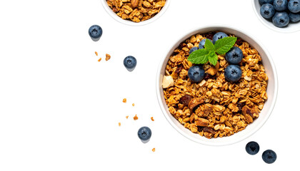 Overhead view showcases granola bowls with blueberries and mint against a black backdrop