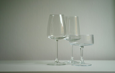 Three different glass goblets on the table. Glassware for alcoholic drinks. Barware.