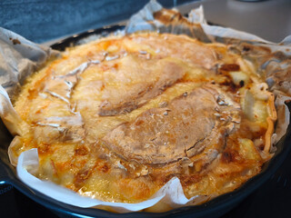 Hot Tartiflette with melted golden Reblochon cheese crust and steam.