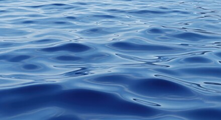 Naklejka premium Close up of deep blue water surface with gentle ripples and reflections