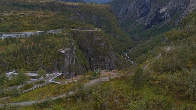 High drone angle of tourists at Voringfossen canyon lookout, Norway