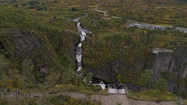 Scenic aerial of Voringfossen viewpoints crowded with tourists, Norway
