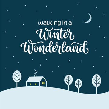 Walking in a winter wonderland hand lettered phrase over snowy night landscape with house and trees