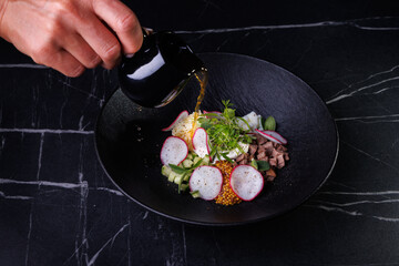 Soup Bowl With Radish, Beef, Eggs, Greens, And Delicate Golden Broth Pour