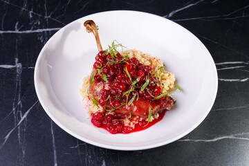 Gourmet Lamb Shank With Cranberry Sauce On Creamy Risotto