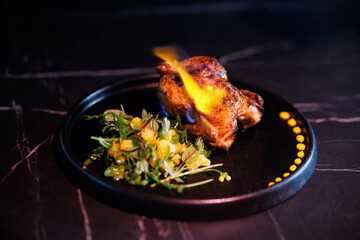 Roasted Chicken Leg Plate with Fresh Greens and Sauces on Dark Marble