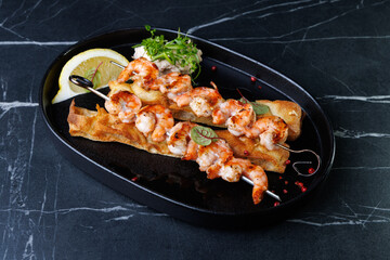 Gourmet Shrimp Skewers on Crispy Bread with Lemon Wedge and Fresh Green