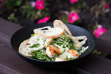 A Picnic Dish in the Garden with Yogurt, Roasted Chicken. brightly blooming Flowers