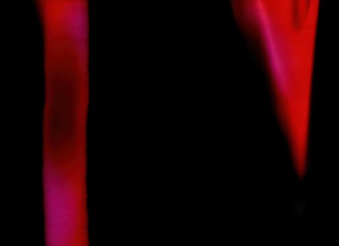 Dynamic red-pink vertical light streaks with sharp color definition and angular bokeh effect creating energetic compositional movement against dark background. Authentic film photography effect showca