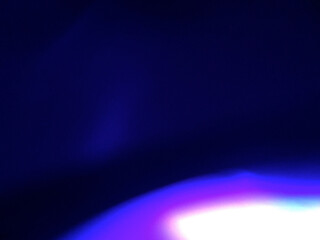 Spectacular purple-blue gradient bokeh composition with bright cyan-white luminous sphere creating cool-tone layered effect and sophisticated atmospheric glow. Authentic film photography effect showca