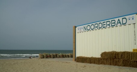 Colorful beach huts lined along a sandy coastline at Texel Netherlands