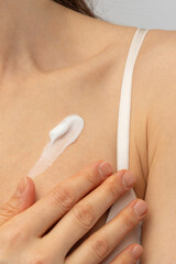 A smear of cream on a woman's shoulder