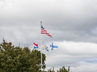 Flags of four nations flying above Fort Christina Park in Wilmington, Delaware