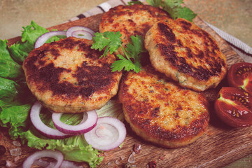 fried chicken cutlets, minced chicken, with vegetables, on a cutting board, with vegetable salad, top view, homemade, no people,