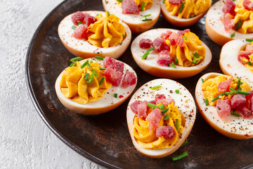 Spicy, stuffed ramen eggs, with bacon and green onions, homemade, no people,