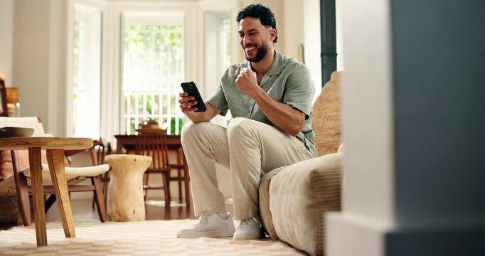 Streaming, fist pump and man on sofa with phone, goal or celebration in soccer tournament. Success, sport and football fan in house with technology, score lead and excitement in game broadcast.