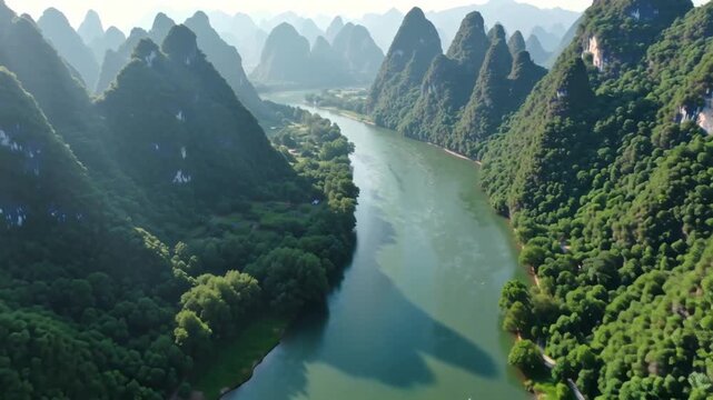 A sweeping 4K aerial cinematic shot of the Yulong River meandering gracefully through dramatic karst mountain peaks near Yangshuo in China's Guangxi Region.