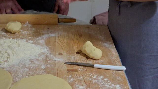 Kneaded flour cut on a wooden board
