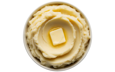 A top-down photograph of creamy mashed potatoes served in a white ceramic bowl against a clean white background. The potatoes are perfectly smooth and fluffy with a rich, buttery texture, showing gent