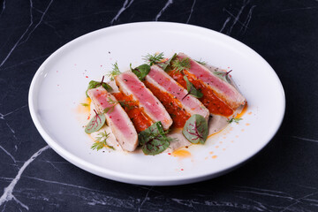 Seared Tuna Steak Slices on Creamy Sauce with Fresh Greens