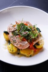 Gourmet Pork With Potatoes and Fresh Greens Plated