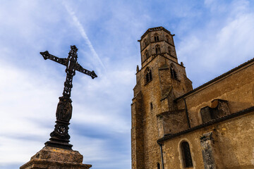 The church of Saint-Michel and its calvary, in the medieval village of Mauvezin, in the Gers, in Occitanie, France.