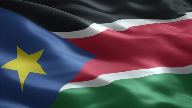 A close-up shot of the South Sudanese flag waving gently, showcasing its vibrant colors and distinct design.