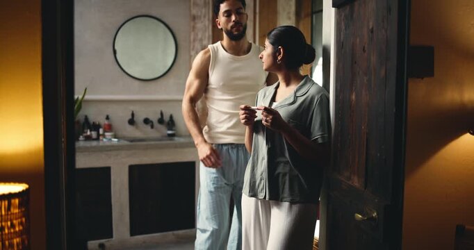 Night, waiting and couple with pregnancy test, nervous and home with fertility issues. Support, evening or man with woman, pregnant or negative results with anticipation, reading ovulation or anxiety