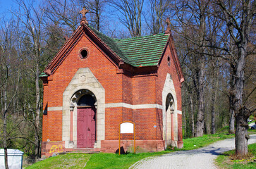 Quaint brick chapel nestled amongst towering trees