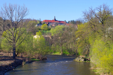 Quaint European town along river in vibrant springtime, Bardo, Poland