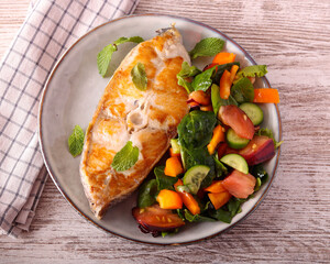Fried white fish steak with salad