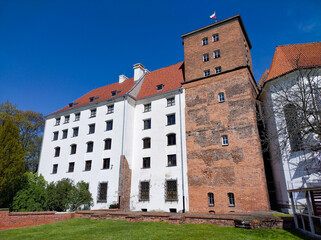 Explore stunning Polish castle under clear blue skies, Brzeg, Poland