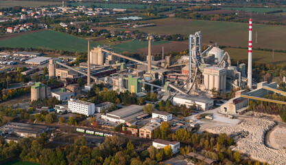 Aerial view of large cement factory complex with industrial smokestacks and quarry, Lafarge cement plant, Czech Republic