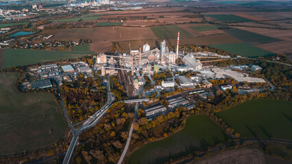 Aerial view of large cement factory complex with industrial smokestacks and quarry, Lafarge cement plant, Czech Republic
