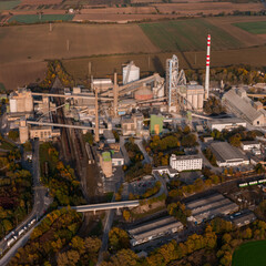Aerial view of large cement factory complex with industrial smokestacks and quarry, Lafarge cement plant, Czech Republic