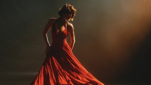 Elegant Woman in Red Gown Posing under Dramatic Spotlight on Stage. Passionate Dance, Luxury Performance, Cinematic Motion.