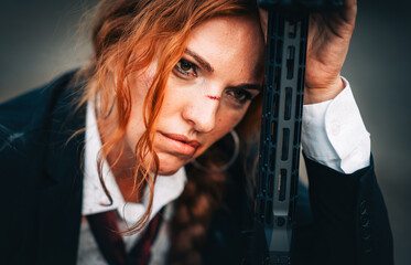 Redhead woman in a suit with a rifle